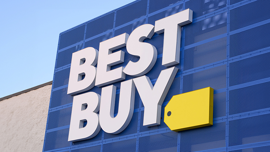 An image of the exterior sign of a Best Buy store set against a blue sky